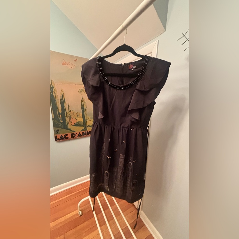 Black Ruffled Dress with Beaded Neckline and City Skyline